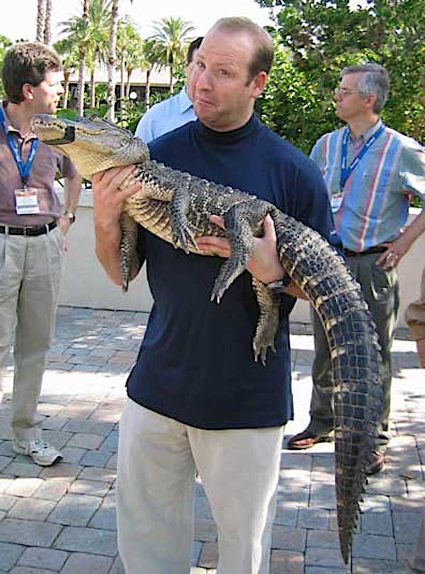 photo of man with alligator